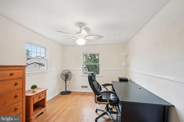 a view of a workspace with furniture and a window