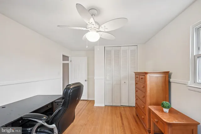a view of a workspace with furniture and a potted plant
