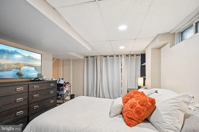 a bedroom with a bed and a flat screen tv