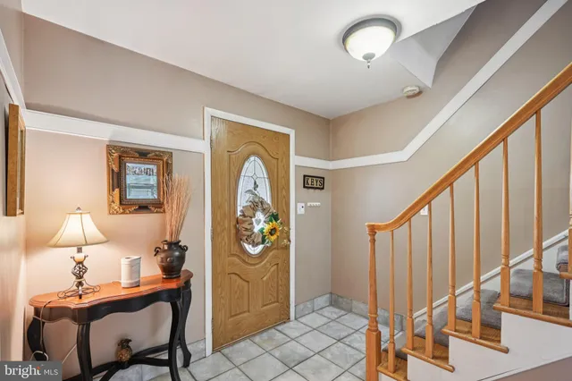 a view of a hallway with workspace and a window