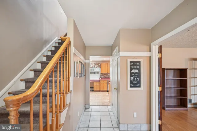 a view of an entryway with wooden floor and livingroom