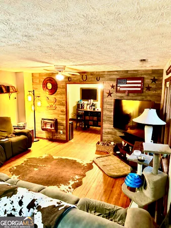 a view of a kitchen with kitchen island granite countertop a sink and appliances