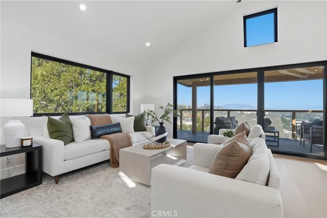 a spacious bedroom with a bed and a chandelier