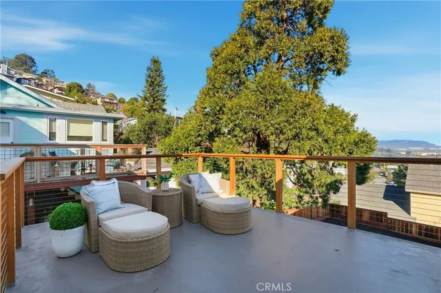 a bedroom with a bed chandelier and a window
