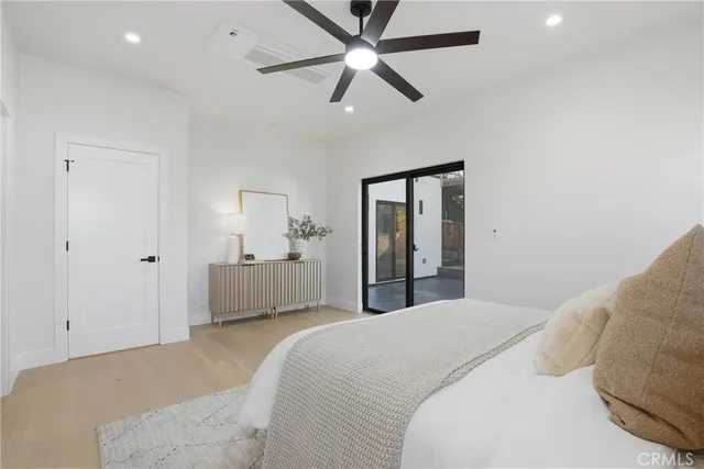 a bedroom with a bed and a night stand