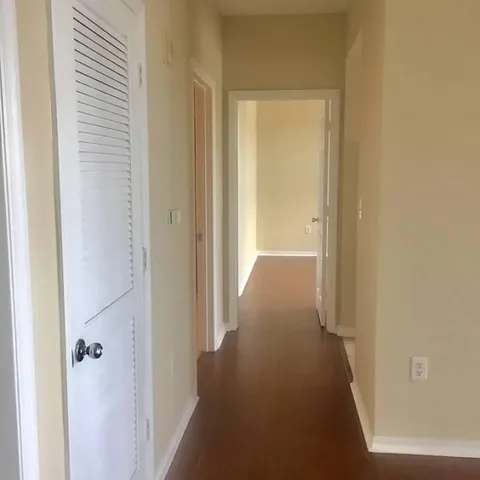 a view of a hallway with a wooden door