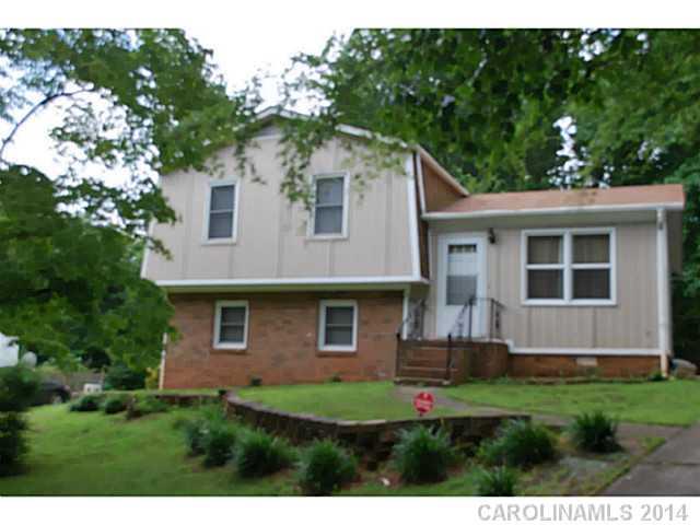 6137 Trotters Ridge Road Charlotte, NC 28227 - Photo 1 of 11 a view of a yard in front of a house with plants and large tree