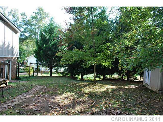 6137 Trotters Ridge Road Charlotte, NC 28227 - Photo 11 of 11 a backyard of a house with lots of green space