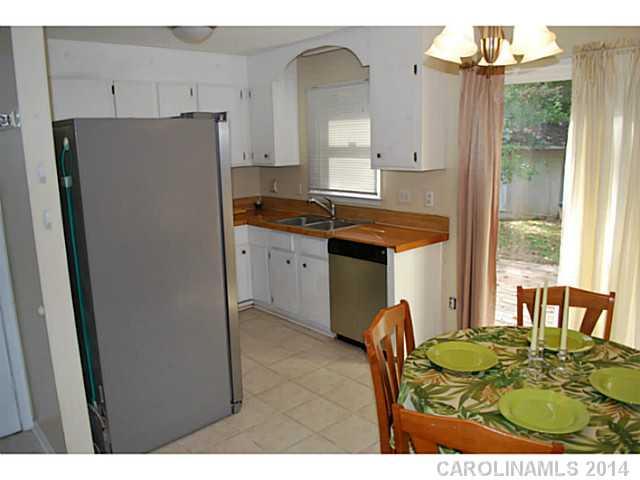 6137 Trotters Ridge Road Charlotte, NC 28227 - Photo 4 of 11 a kitchen with stainless steel appliances granite countertop a refrigerator a sink a stove and island