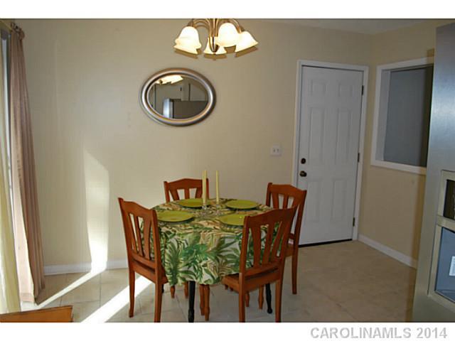 6137 Trotters Ridge Road Charlotte, NC 28227 - Photo 6 of 11 a view of a dining room with furniture and chandelier