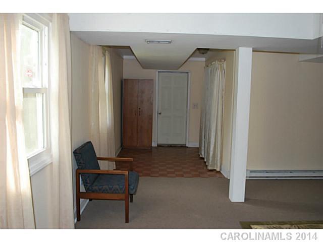 6137 Trotters Ridge Road Charlotte, NC 28227 - Photo 8 of 11 a view of a hallway with front door and wooden floor