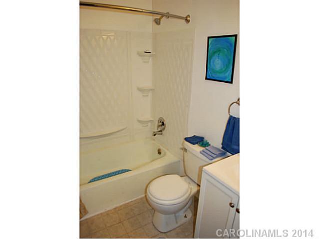 6137 Trotters Ridge Road Charlotte, NC 28227 - Photo 9 of 11 a white toilet sitting next to a bath tub and a shower