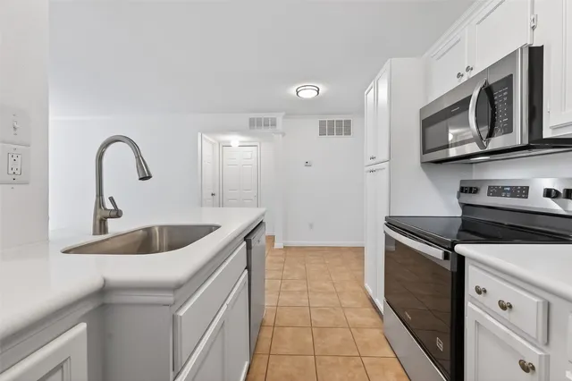 a kitchen with stainless steel appliances granite countertop a sink and a stove