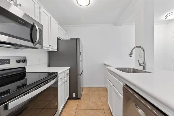 a kitchen with stainless steel appliances granite countertop a sink stove and microwave