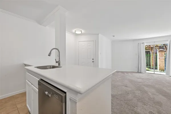 a room with a sink a table and chairs