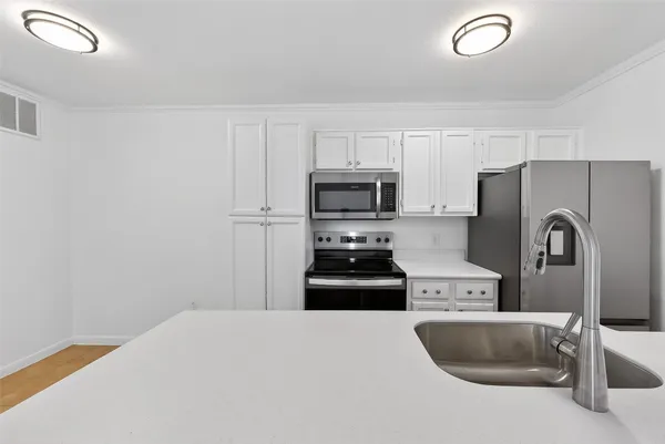 a kitchen with stainless steel appliances granite countertop a refrigerator sink and stove