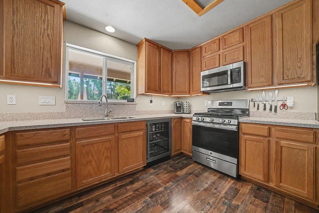 26845 Spring Court Pioneer, CA 95666 - Photo 7 of 89 a kitchen with stainless steel appliances granite countertop a stove a sink dishwasher and a microwave oven with cabinets