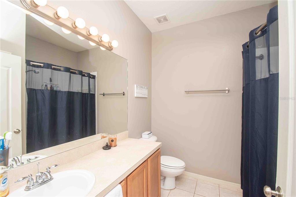 269 Fairmont Drive Spring Hill, FL 34609 - Photo 15 of 32 a bathroom with a sink a toilet a mirror and shower