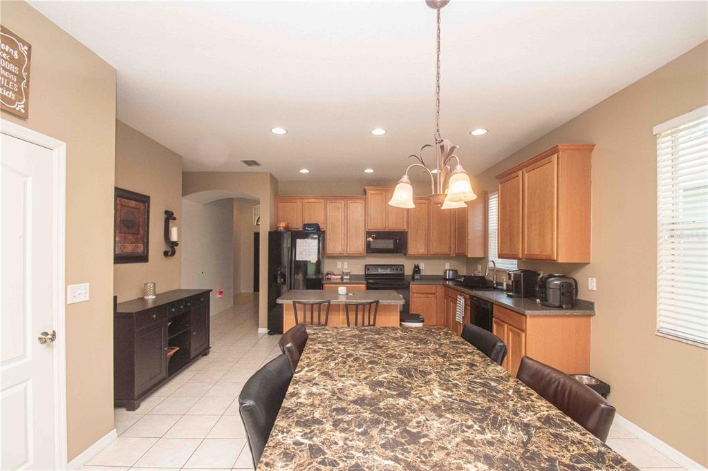 269 Fairmont Drive Spring Hill, FL 34609 - Photo 4 of 32 a large kitchen with kitchen island a large counter top space appliances and a window