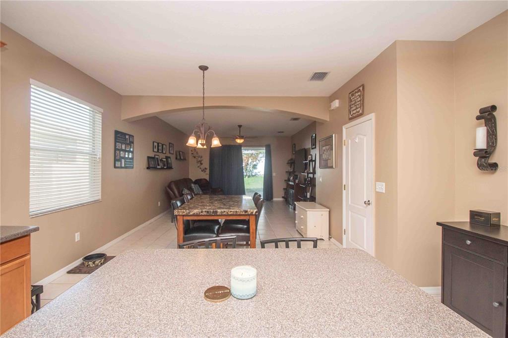 269 Fairmont Drive Spring Hill, FL 34609 - Photo 6 of 32 a living room with furniture and a chandelier