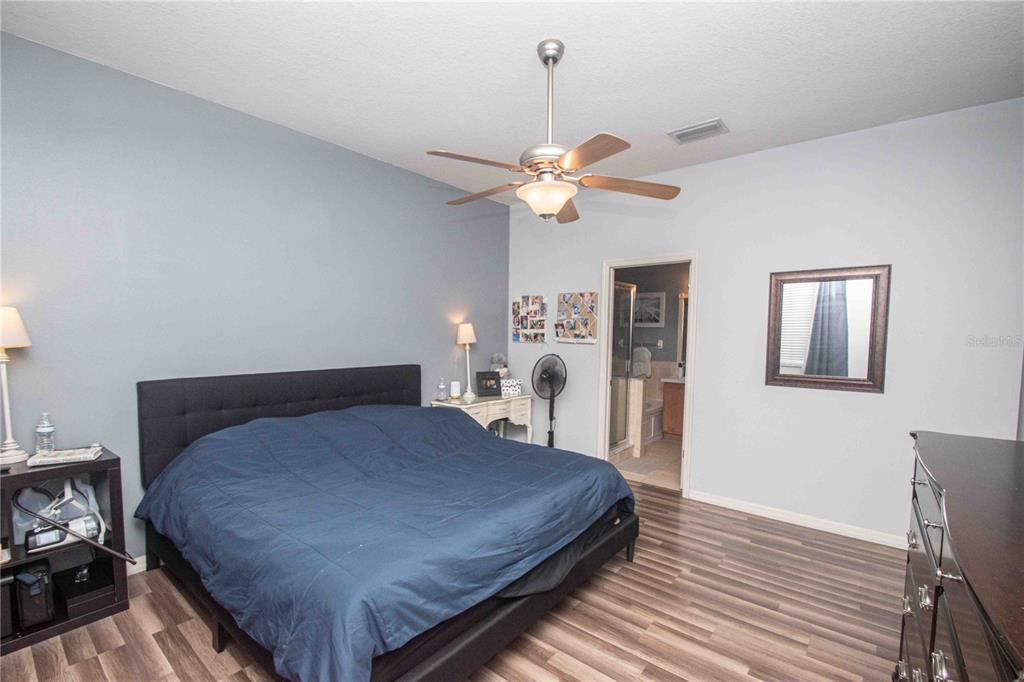 269 Fairmont Drive Spring Hill, FL 34609 - Photo 8 of 32 a bedroom with a bed chandelier and a window