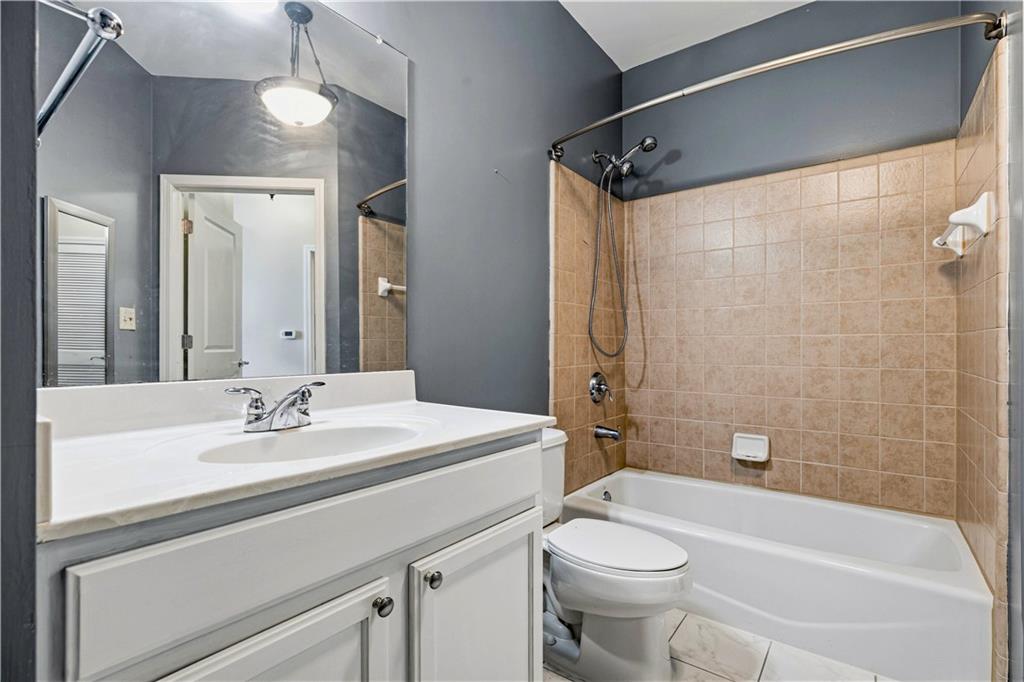3040 Peachtree Road Northwest, Unit 1503 Atlanta, GA 30305 - Photo 23 of 38 a bathroom with a sink a toilet and shower