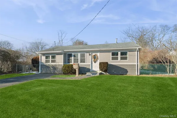 a view of a house with a yard and sitting area