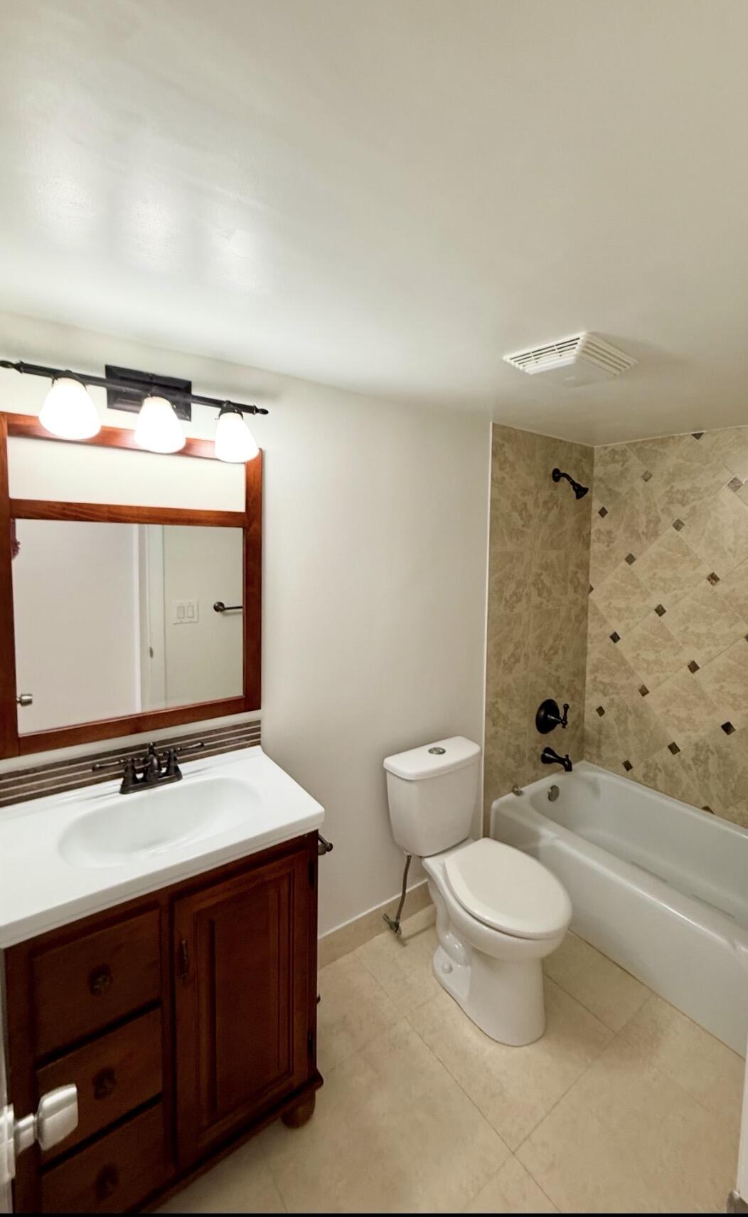 875 Northwest 13th Street, Unit 405 Boca Raton, FL 33486 - Photo 15 of 16 a bathroom with a sink a toilet and shower