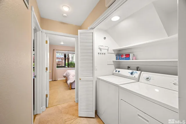 a utility room with cabinets washer and dryer
