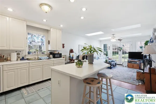 a kitchen with stainless steel appliances kitchen island granite countertop a sink a stove and cabinets