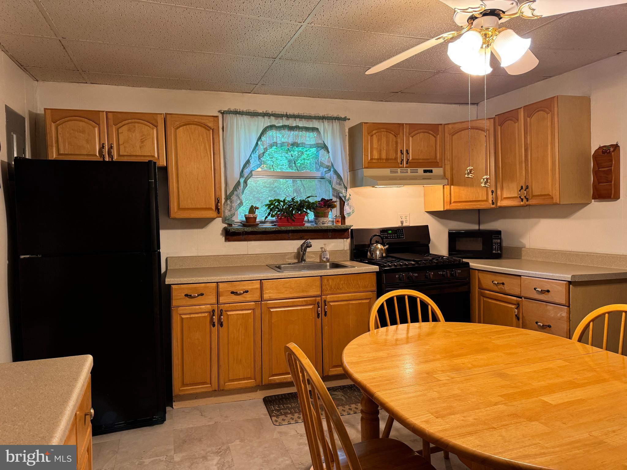 13 Cramer Road Tabernacle, NJ 08088 - Photo 13 of 48 a kitchen with stainless steel appliances granite countertop a stove a refrigerator a sink a dining table and chairs with wooden floor