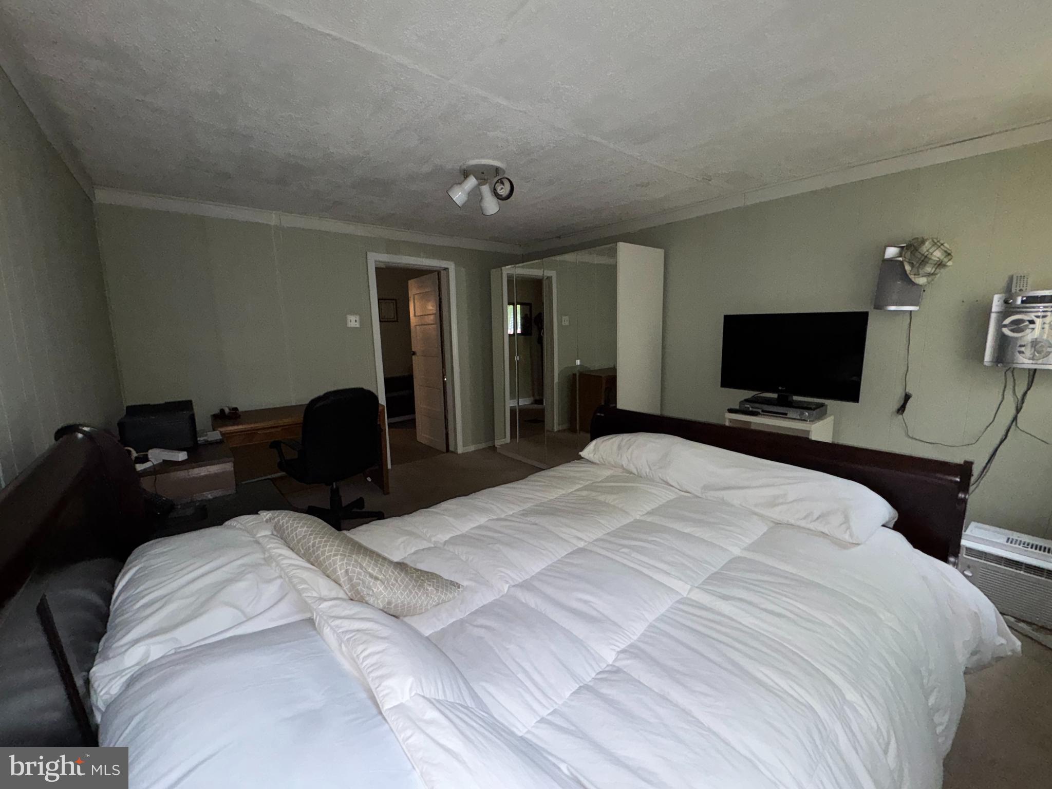13 Cramer Road Tabernacle, NJ 08088 - Photo 35 of 48 a bedroom with a bed and a flat tv screen on wall