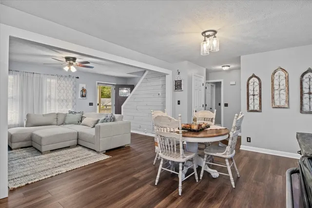 a view of a dining room with furniture and wooden floor