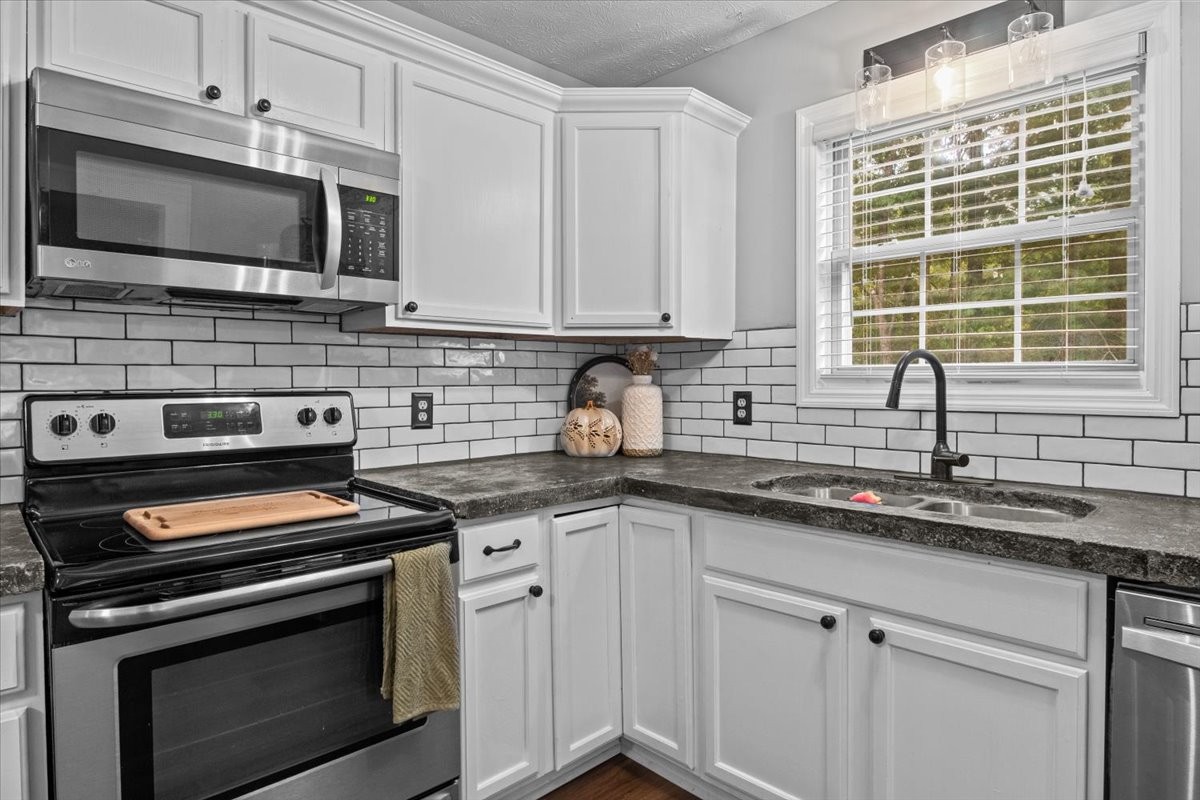 5790 Washer Road Lyles, TN 37098 - Photo 20 of 31 a kitchen with cabinets stainless steel appliances a sink and a window