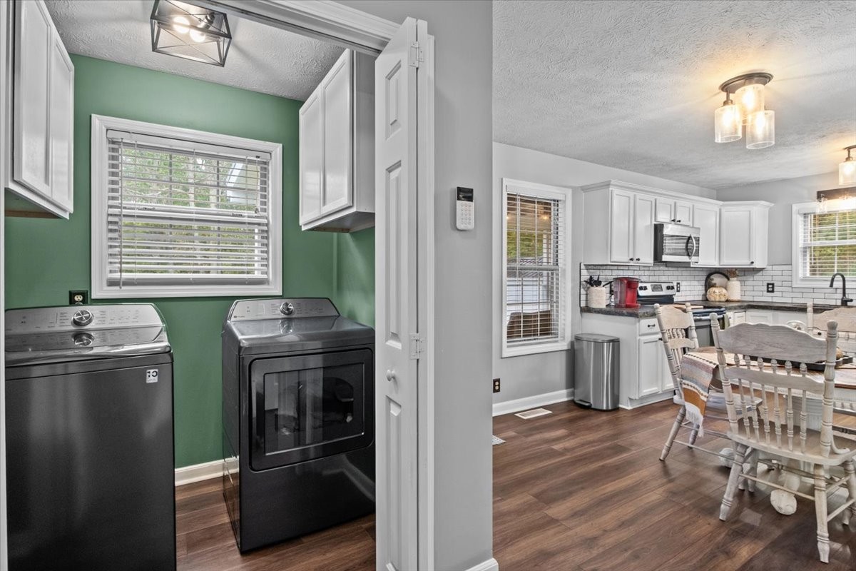 5790 Washer Road Lyles, TN 37098 - Photo 22 of 31 a kitchen with stainless steel appliances granite countertop a refrigerator a stove a sink a dining table and chairs with wooden floor