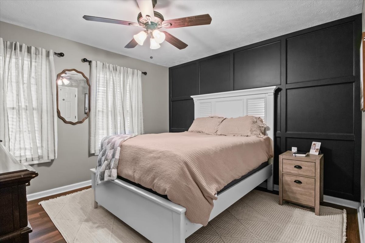 5790 Washer Road Lyles, TN 37098 - Photo 23 of 31 a bed room with a bed a mirror and a chandelier