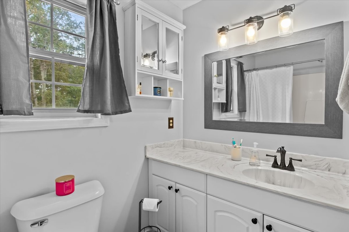 5790 Washer Road Lyles, TN 37098 - Photo 25 of 31 a bathroom with a granite countertop sink vanity mirror next to a window