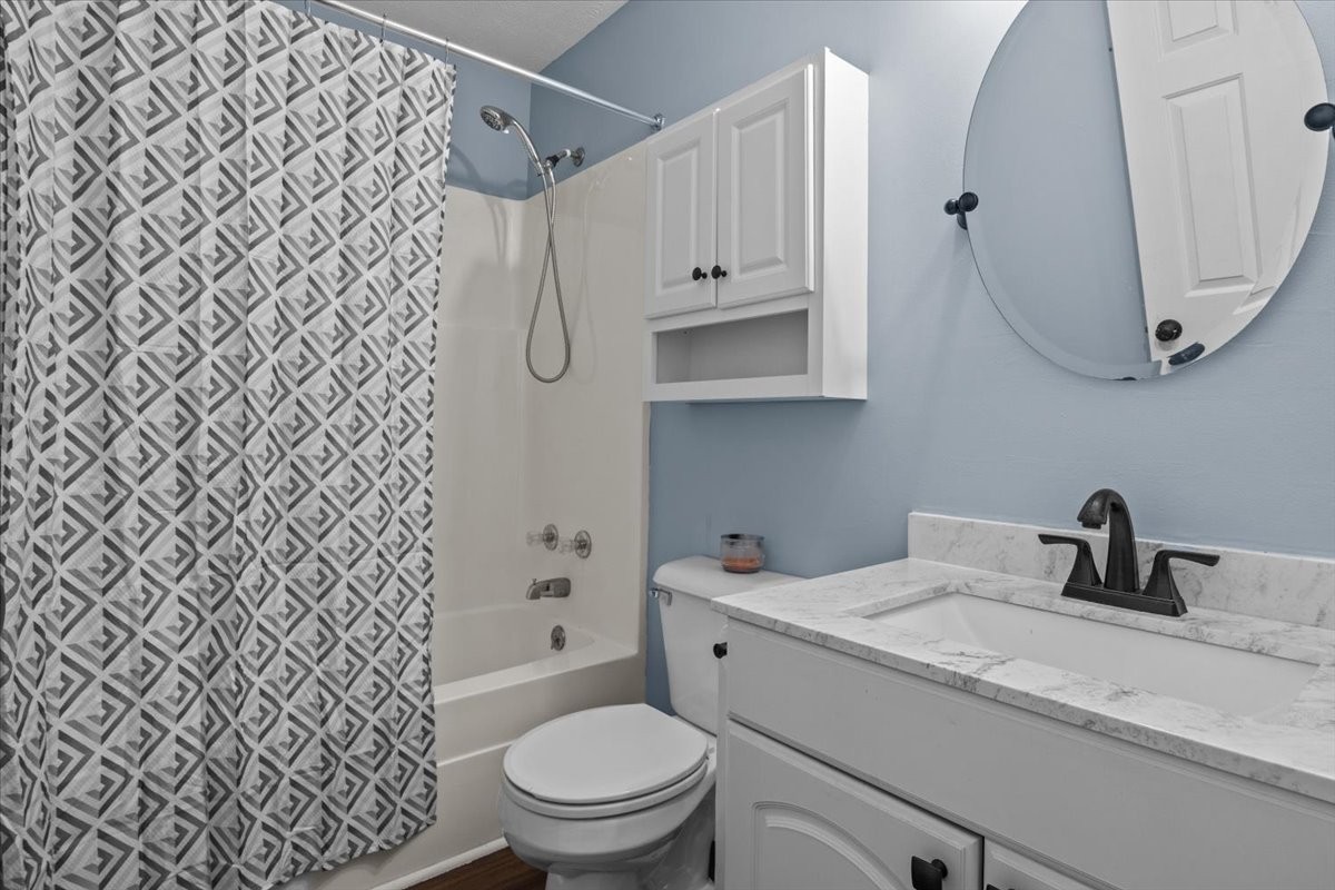 5790 Washer Road Lyles, TN 37098 - Photo 26 of 31 a bathroom with a granite countertop toilet sink and mirror