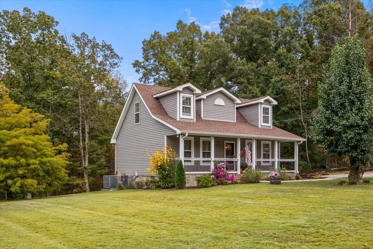 5790 Washer Road Lyles, TN 37098 - Photo 3 of 31 a front view of a house with a garden