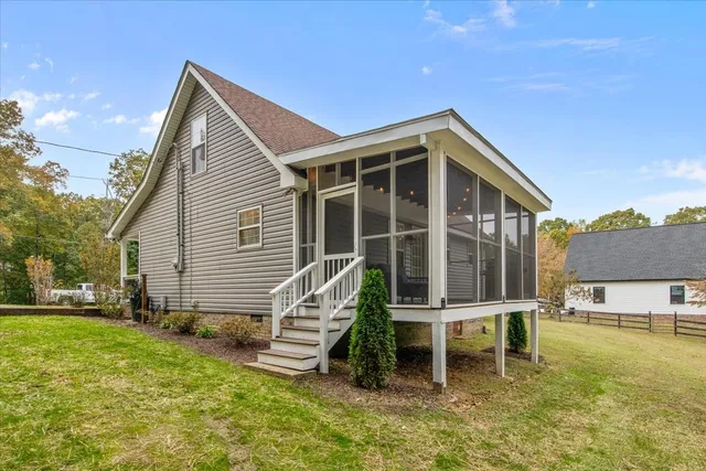 a wooden bench sitting in front of a house
