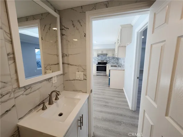 a bathroom with a sink mirror and shower