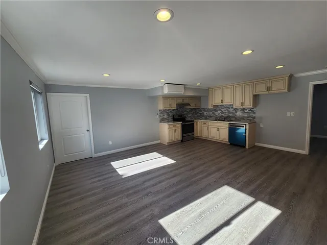 a kitchen with a wooden floor and window