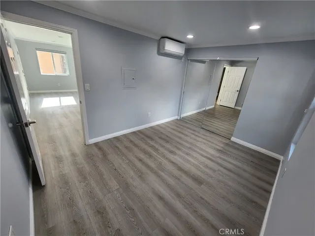 wooden floor in an empty room with a mirror