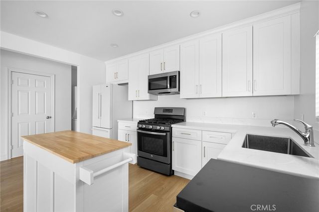 a kitchen with a sink stove and refrigerator