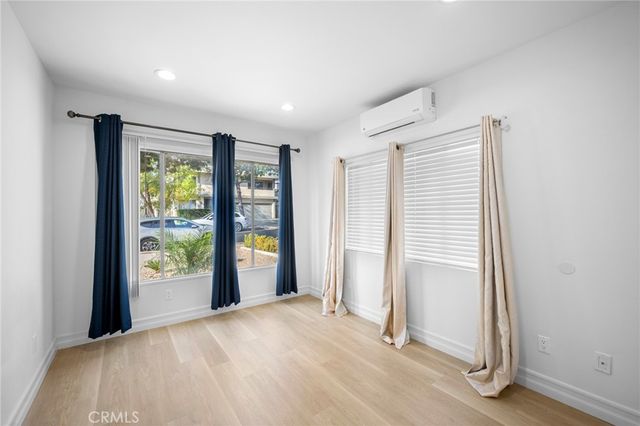 an empty room with windows and closet