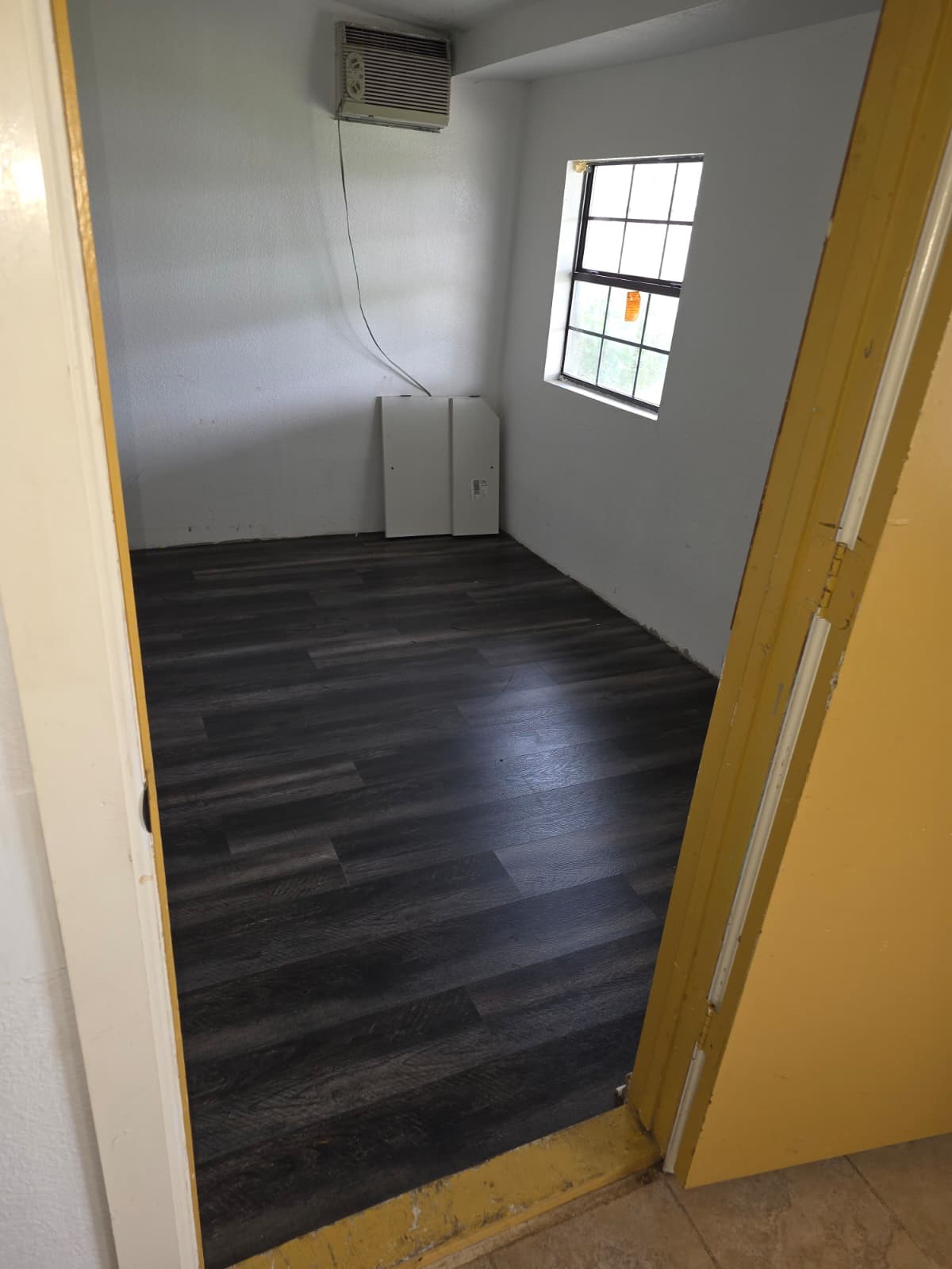 8214 Barkley Street Houston, TX 77017 - Photo 8 of 9 Bedroom 4 with wood-look flooring and window AC unit.