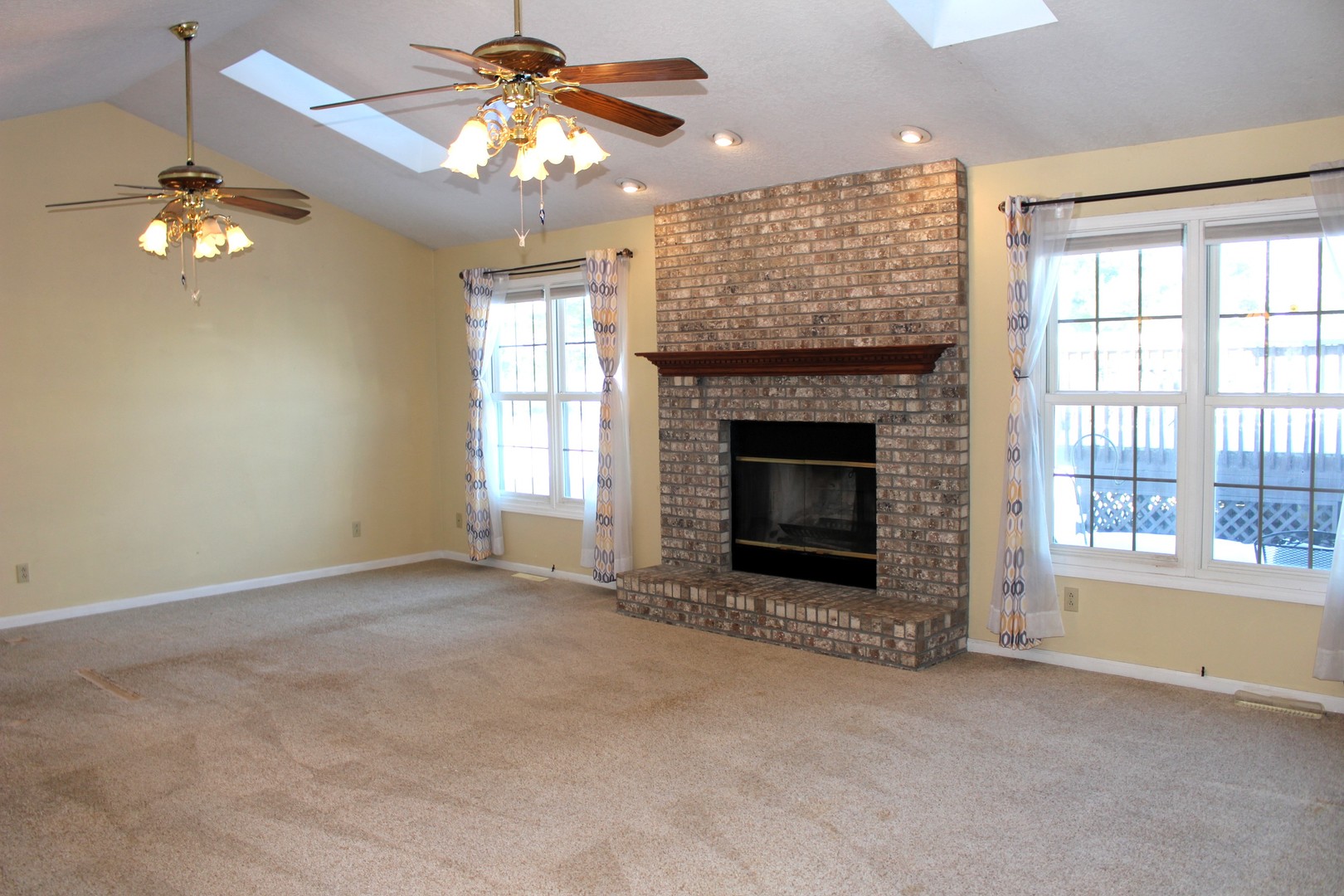 7629 White Oak Road Clinton, IL 61727 - Photo 17 of 47 an empty room with chandelier fan and windows