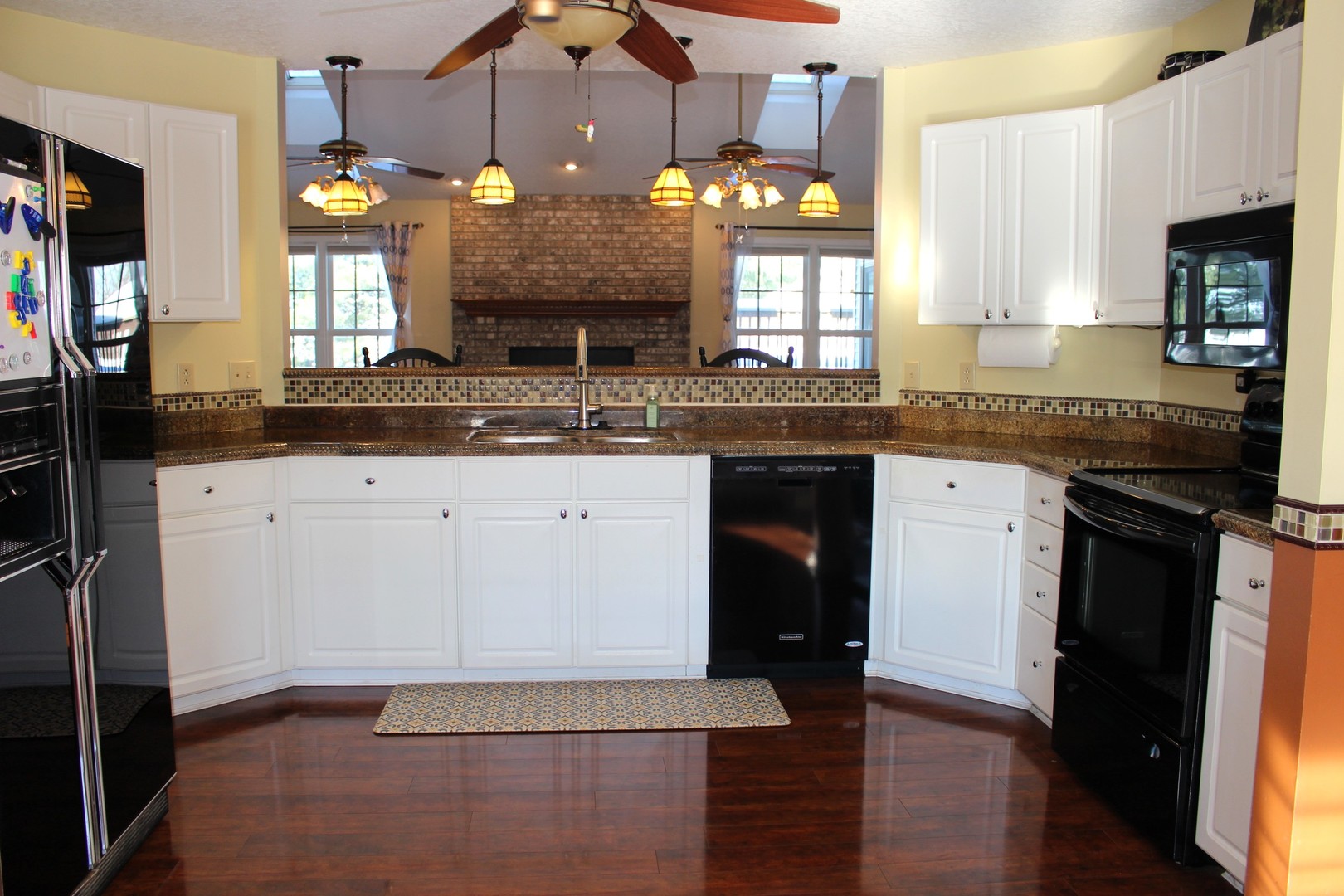 7629 White Oak Road Clinton, IL 61727 - Photo 20 of 47 a large kitchen with granite countertop a sink and cabinets