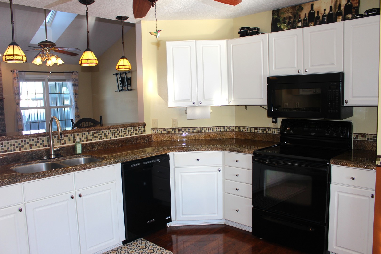7629 White Oak Road Clinton, IL 61727 - Photo 23 of 47 a kitchen with granite countertop a sink stainless steel appliances and cabinets
