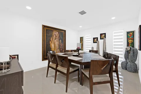 a view of a dining room with furniture and window